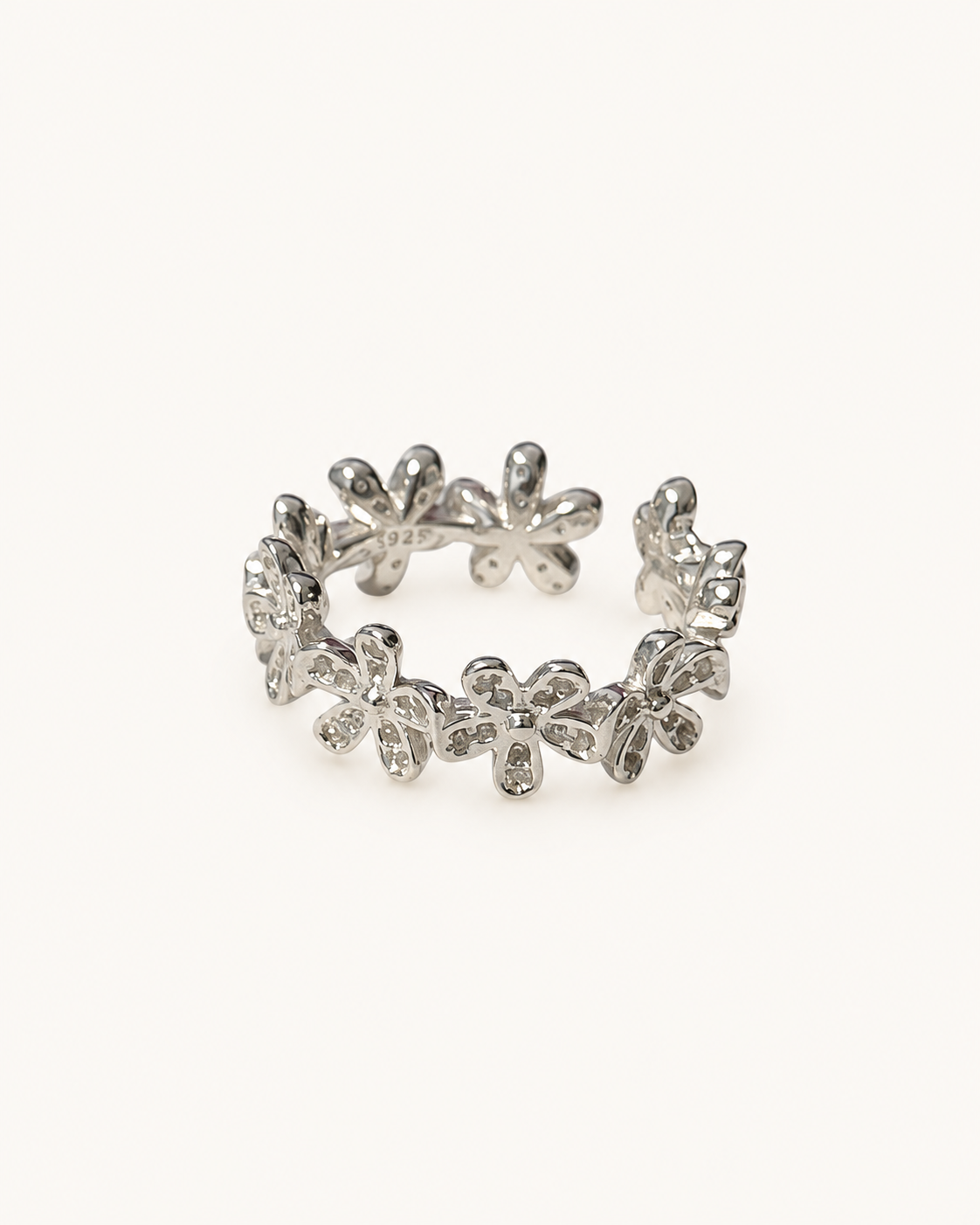 Silver floral open ring on ivory background